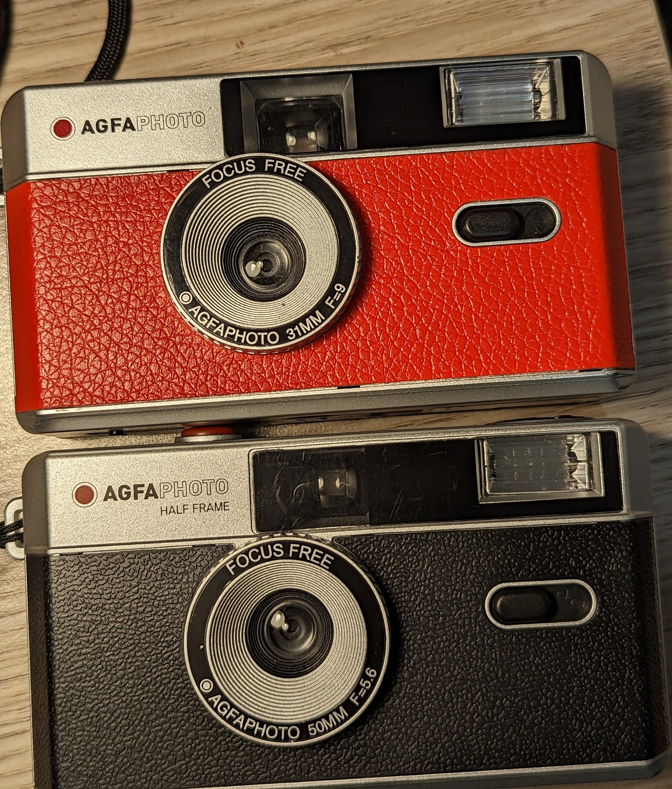 Agfaphoto film camera (top in red) is full frame and the new half frame version